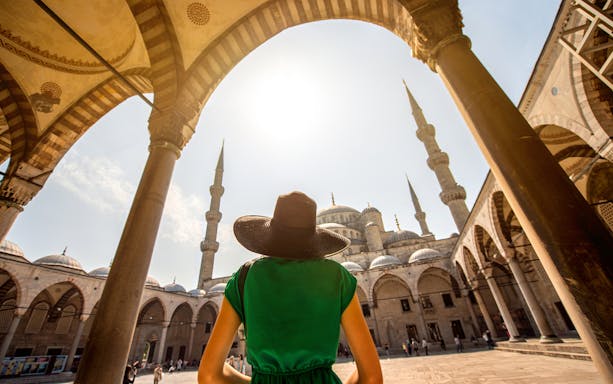 Visitor admiring the Blue Mosque's architecture during a guided tour in Istanbul.