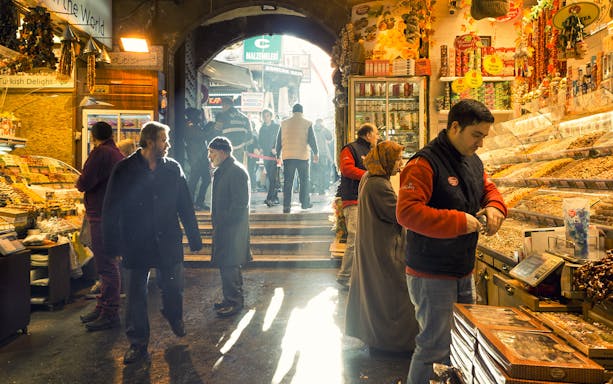 Grand Bazaar walking tour with people shopping for spices and goods in Istanbul.