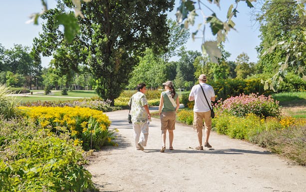 Visitors walking through gardens on the Gödöllő Royal Sisi tour near Budapest.