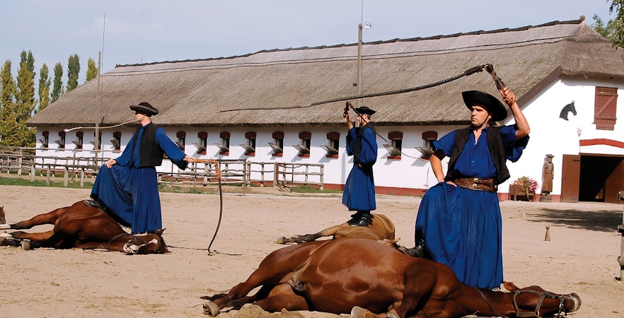 Horsemen performing traditional show in Kecskemet, Hungary during Puszta day trip from Budapest.