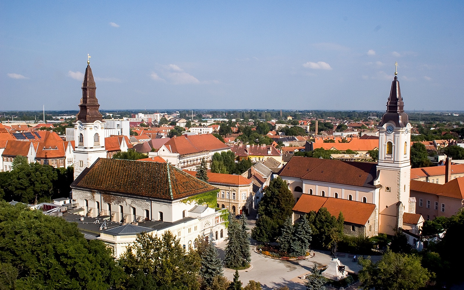 Kecskemet cityscape with historic churches on Puszta day trip from Budapest.