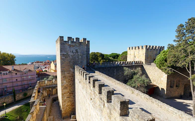 Surrounding wall of St. George’s Castle in Lisbon with city and sea view.