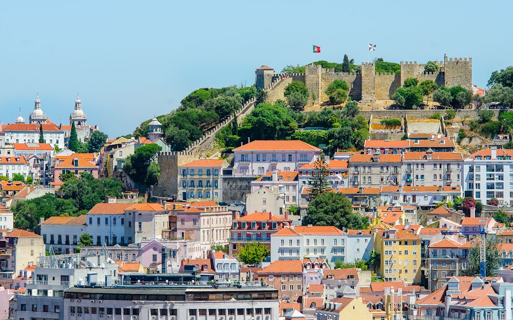 St. George Castle overlooking Lisbon's colorful buildings and lush greenery.