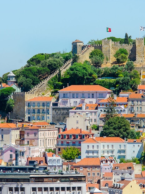 St. George Castle overlooking Lisbon's colorful buildings and lush greenery.