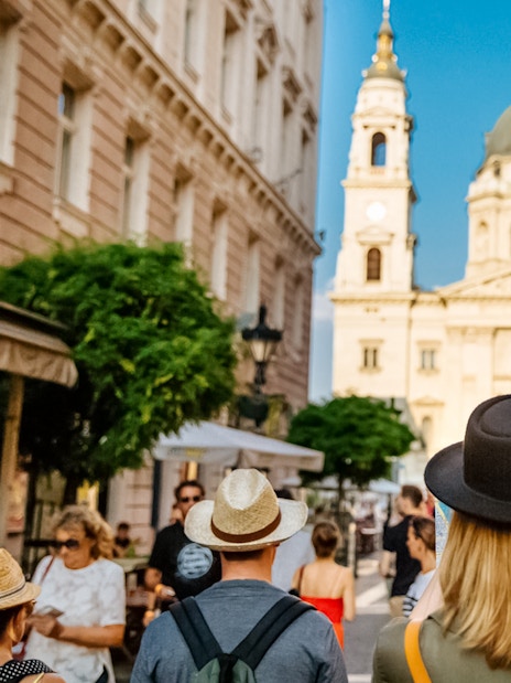 Tourists walking towards St. Stephen's Basilica in Budapest during a guided tour.