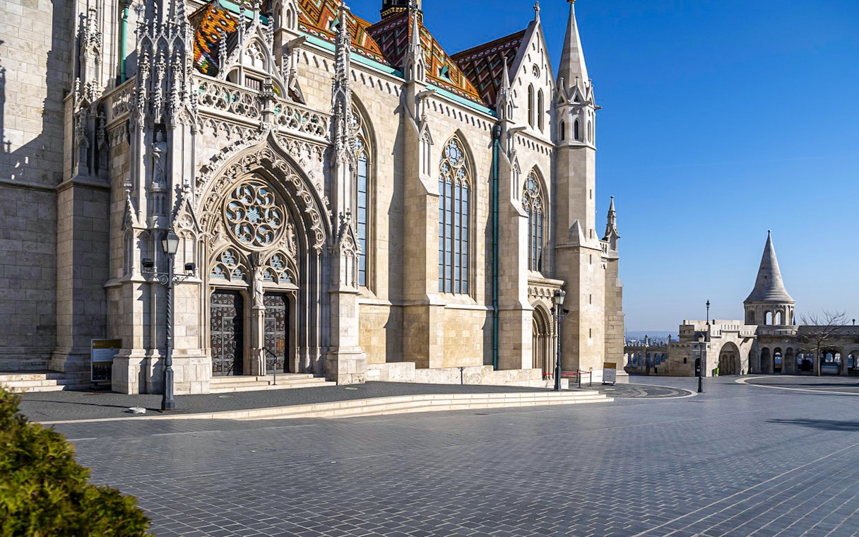 Matthias Church and Fisherman's Bastion in Budapest, Hungary, under a clear blue sky.