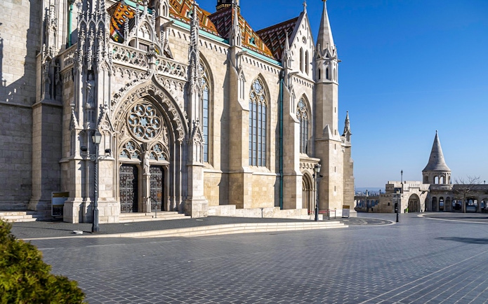 Matthias Church and Fisherman's Bastion in Budapest, Hungary, under a clear blue sky.