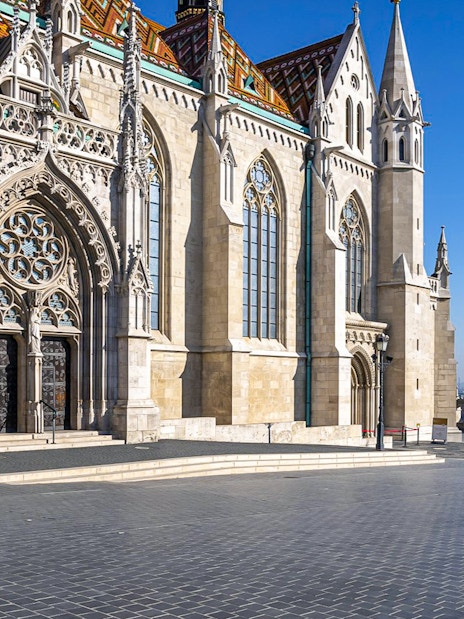 Matthias Church and Fisherman's Bastion in Budapest, Hungary, under a clear blue sky.