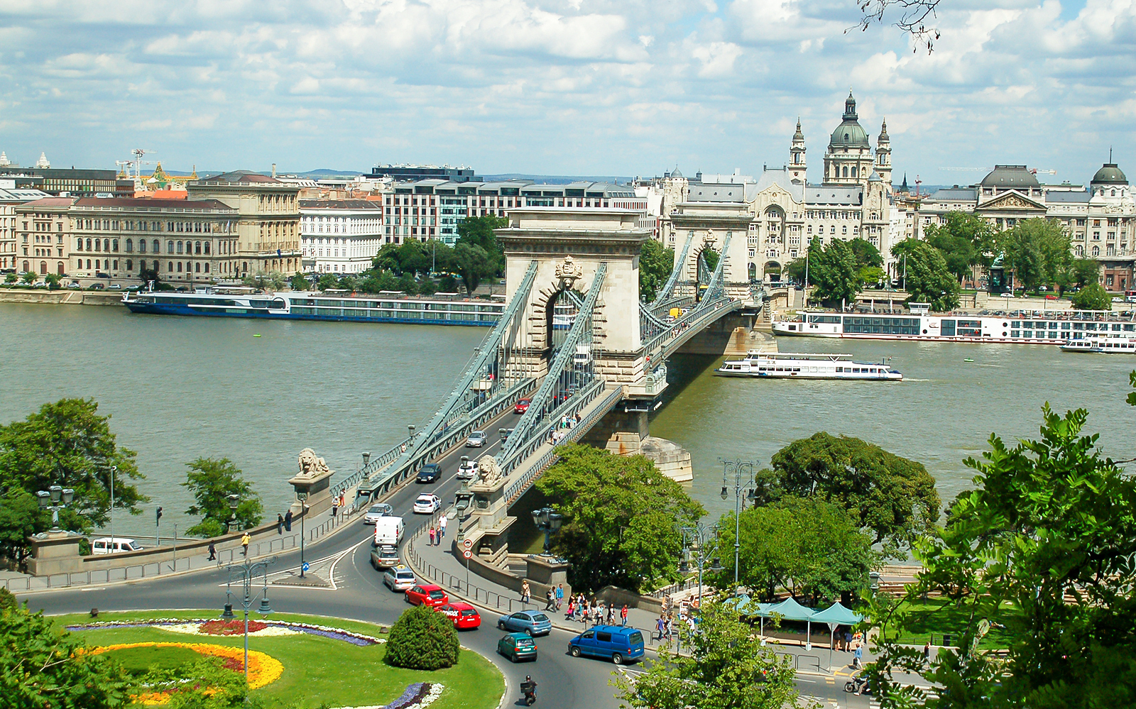 Chain Bridge over Danube River in Budapest with cityscape in background.