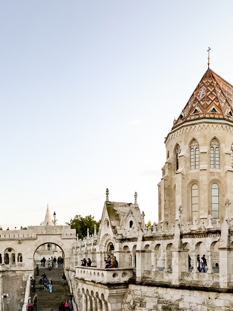 Fisherman's Bastion in Budapest with tourists exploring the historic architecture.