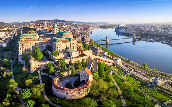 Aerial view of Buda Castle and Chain Bridge along the Danube River in Budapest.