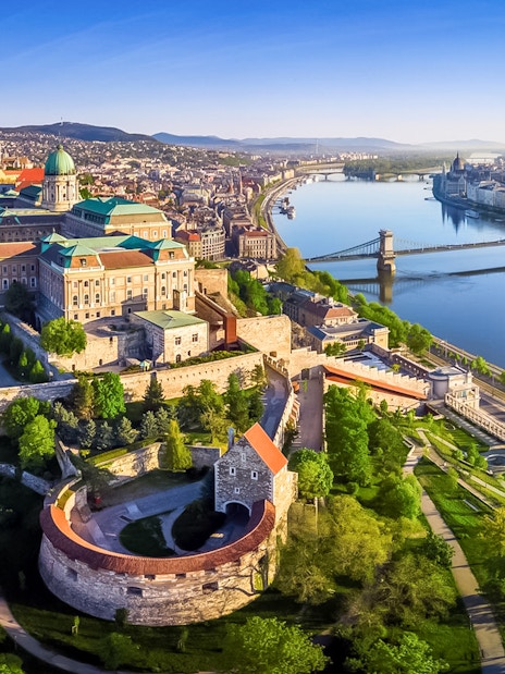 Aerial view of Buda Castle and Chain Bridge along the Danube River in Budapest.