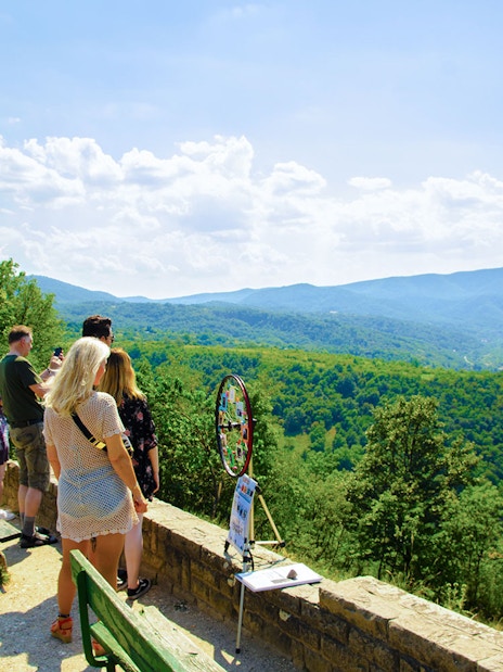 Tourists enjoying the scenic view of the Danube Bend from a lookout point near Budapest.