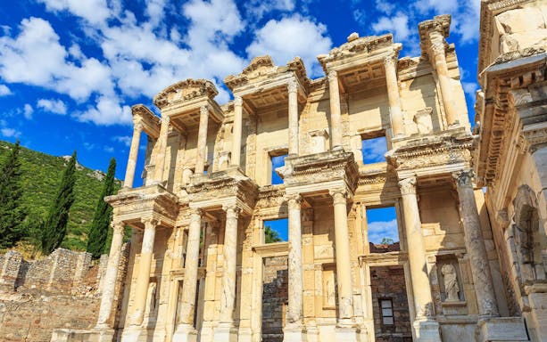Ancient Library of Celsus in Ephesus, Turkey, with detailed columns and blue sky.