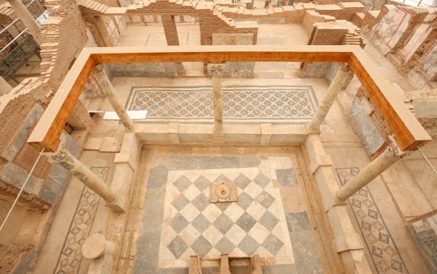 Ancient Roman terrace house ruins in Ephesus with mosaic floors and columns.