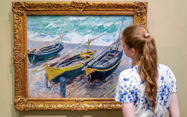 Visitor viewing a painting of boats at the Hungarian National Gallery.