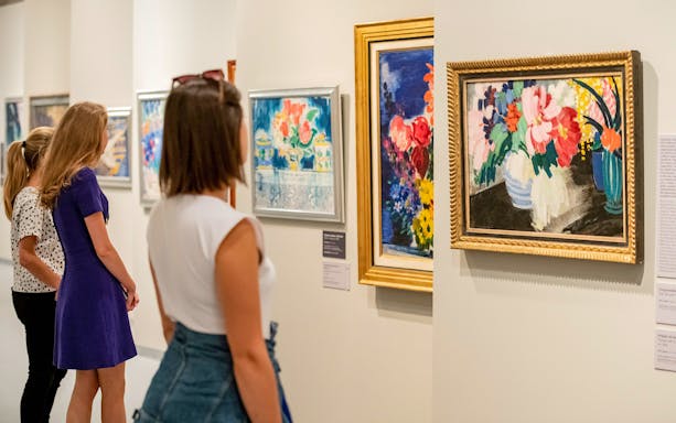 Visitors viewing floral paintings at the Hungarian National Gallery.