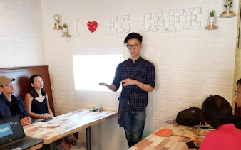 Coffee workshop presentation at Nineteen95 Espresso Bar with attendees listening attentively.
