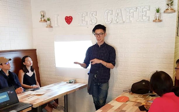 Coffee workshop presentation at Nineteen95 Espresso Bar with attendees listening attentively.