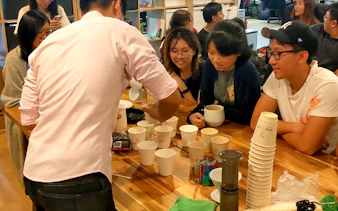 Participants at coffee workshop, Nineteen95 Espresso Bar, learning brewing techniques.