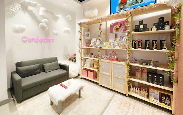 Candle Making Workshops at Candlescape with display shelves and cozy seating area.