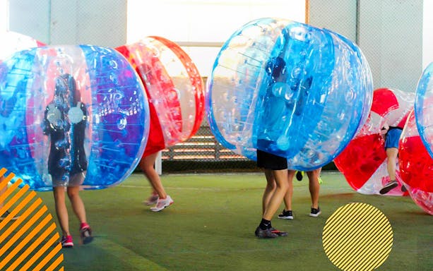 Participants playing bubble soccer at FunEmpire indoor arena.