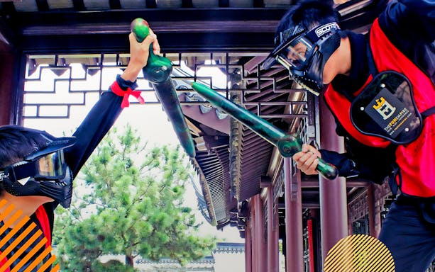 Participants in protective gear engage in a sword-fighting activity at FunEmpire.