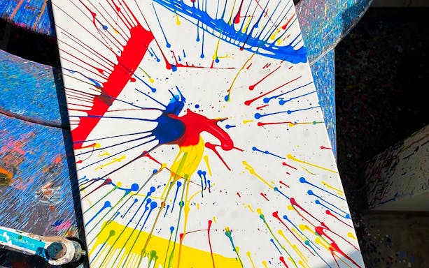Colorful spin art canvas at Spin Paint House experience.