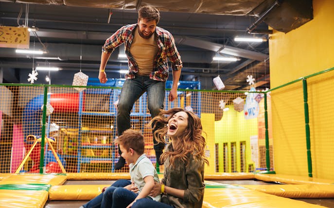Family enjoying trampoline play area at T-Play Khatib indoor playground.