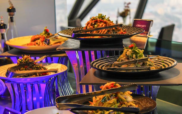 Salad buffet display at ARAS Restaurant with various dishes and tongs.