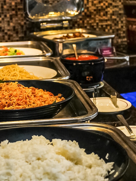 Buffet spread at Atmosphere 360 Revolving Restaurant, featuring rice and noodles.