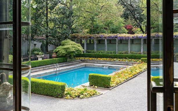 Villa Necchi Campiglio garden view with pool and lush greenery.