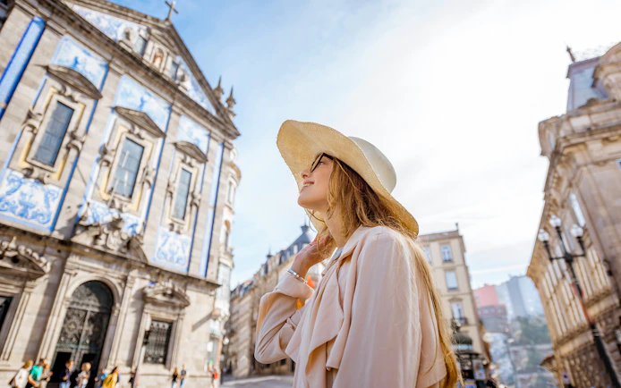 Woman in front of Igreja do Carmo, Porto, during a guided tour from Lisbon.