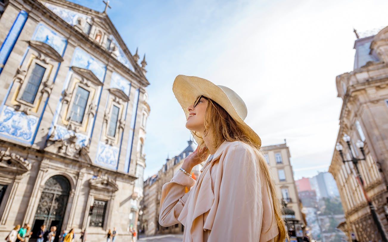 Woman in front of Igreja do Carmo, Porto, during a guided tour from Lisbon.