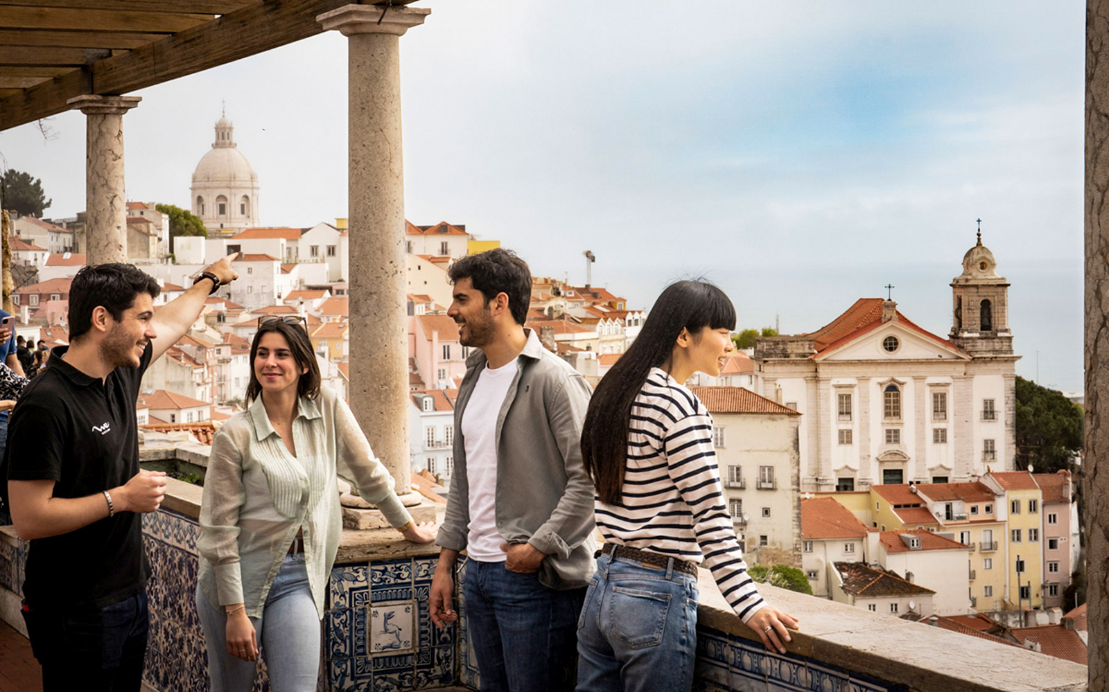 Group enjoying Lisbon's old town view with São Vicente de Fora in the background.