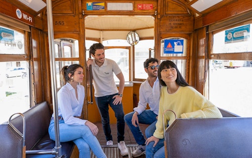 Group enjoying a tram ride in Lisbon's Old Town during the 360º Lisboa SkyWalk tour.