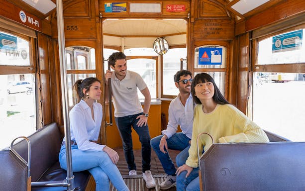Group enjoying a tram ride in Lisbon's Old Town during the 360º Lisboa SkyWalk tour.