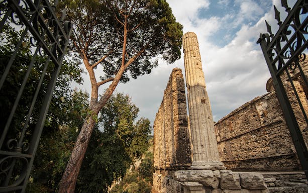 Ancient Roman ruins and trees at Villa Gregoriana, Tivoli, Italy.