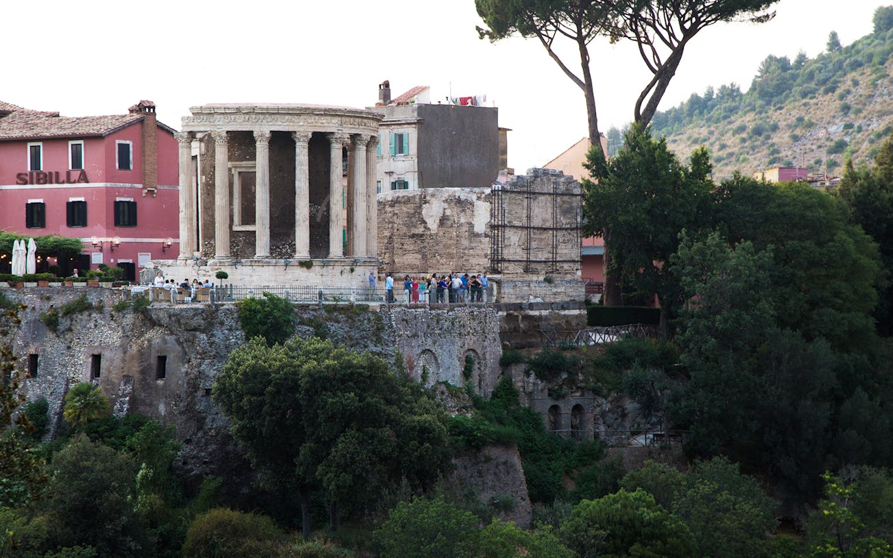 Villa Gregoriana's Temple of Vesta in Tivoli, Italy, with surrounding greenery.