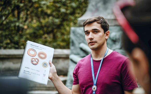 Local guide explaining Polish food items during a traditional food tour.