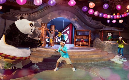 Child posing with Kung Fu Panda character Po at Kung Fu Academy, Motiongate.
