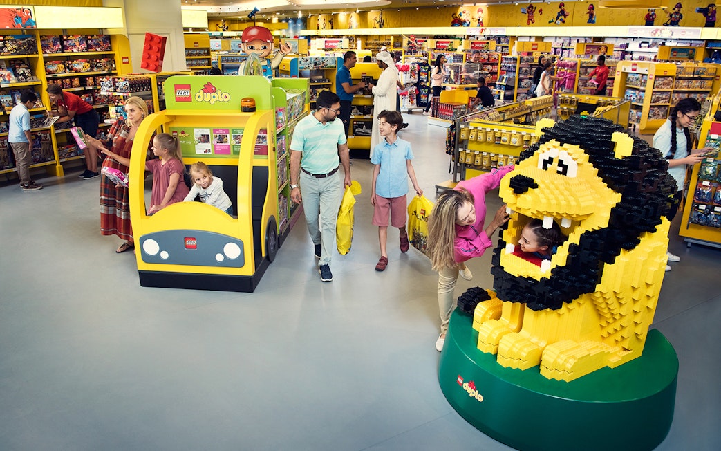 Family enjoying Lego store at Legoland Dubai with 1-Day, 2 Parks Pass.