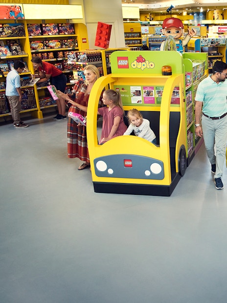 Family enjoying Lego store at Legoland Dubai with 1-Day, 2 Parks Pass.