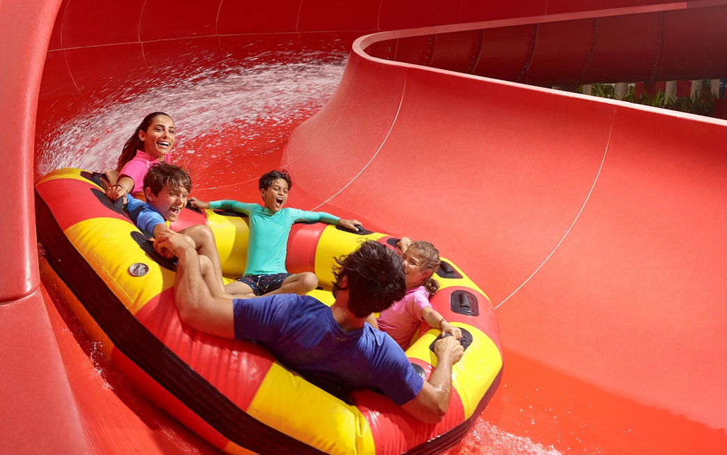 Family riding the Red Rush water slide at LEGOLAND Water Park.
