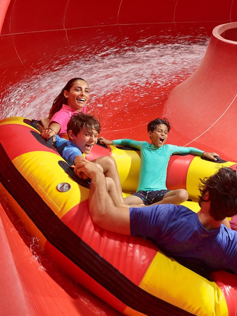 Family riding the Red Rush water slide at LEGOLAND Water Park.