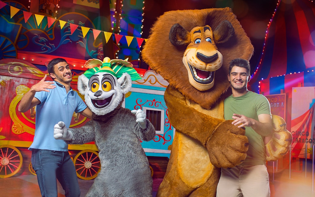Characters from Madagascar with visitors at MOTIONGATE Theme Park, Dubai Parks and Resorts.