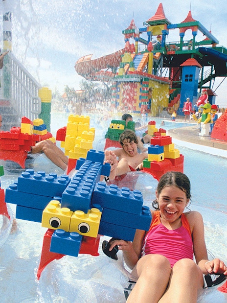 Families enjoying Build A Raft River with LEGO structures at LEGOLAND Water Park.