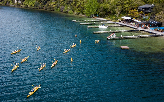 Kayakers paddling on Lake Rotoiti near Manupirua Hot Pools, New Zealand.