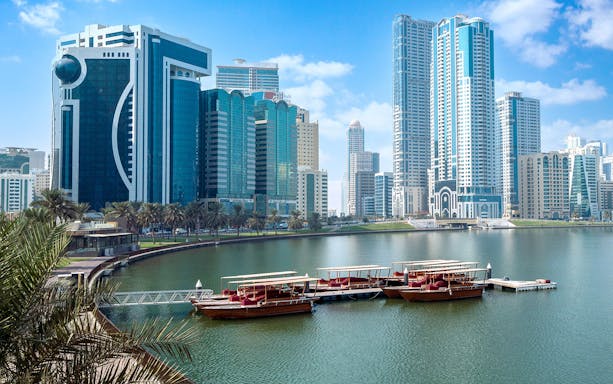 Private boats docked at Khalid Lagoon with Sharjah skyline in the background.