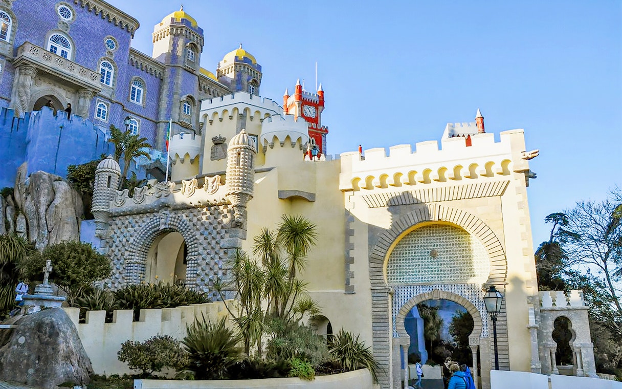 Pena Palace entrance in Sintra, Portugal, showcasing colorful architecture on a full-day tour from Lisbon.